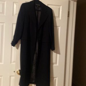 Hardly used Portrait brand long black raincoat lined.